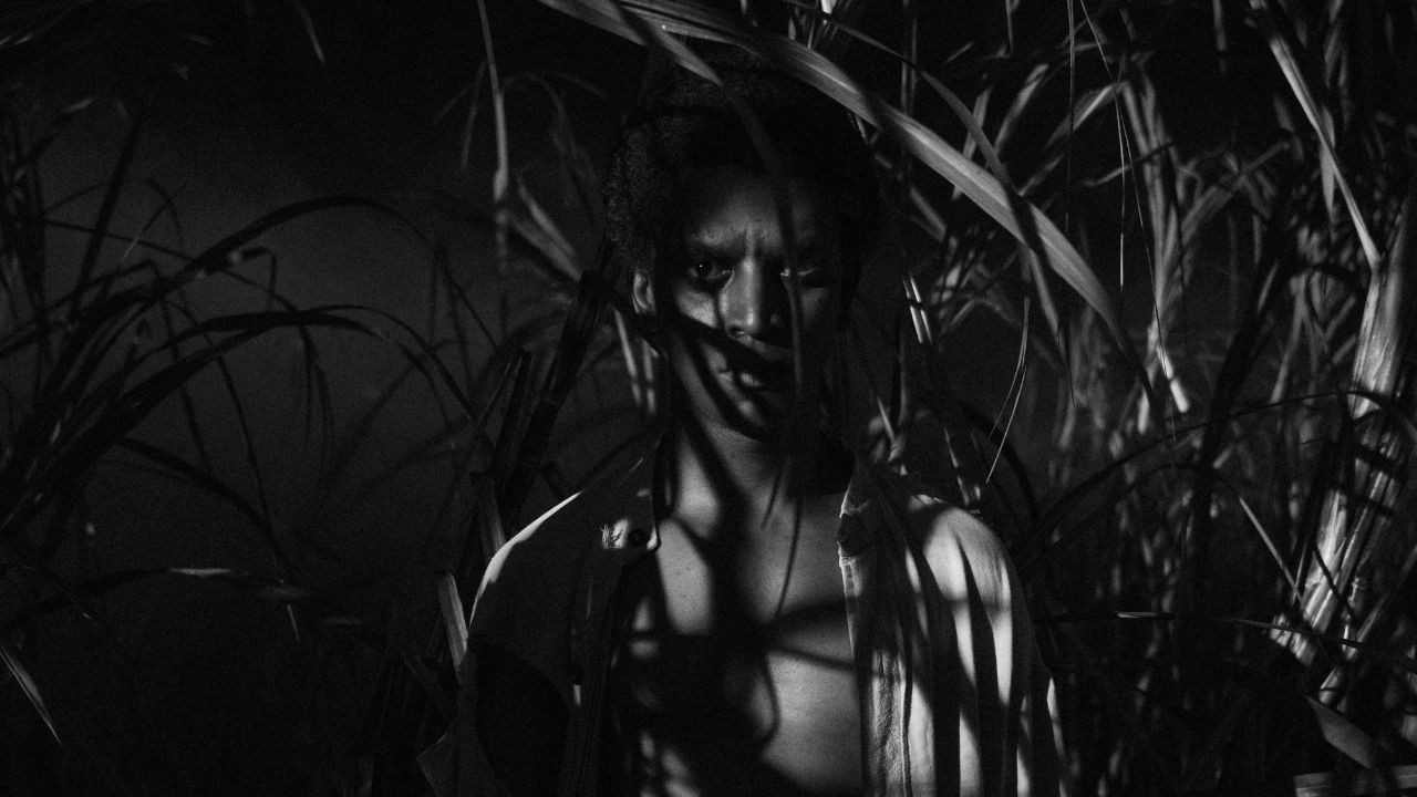 a man standing in the shadows